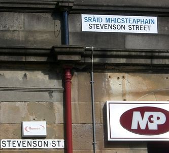 Newer streets signs in parts of western Scotland display names in Scottish Gaelic above English - older signs are in English only. The promotion or proscription of languages is called language planning and is one topic studied in sociolinguistics.