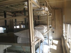 (CC) Photo: Robin Bowers / TrainWeb.com An interior view of a restored Pullman troop sleeper configured for nighttime use.