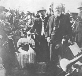 (PD) Photo: Unknown Frank Forward, Sr. (mayor of San Diego) turns the first shovelful of dirt to ceremonially commence construction of the San Diego and Arizona Railway on September 7, 1907. At left is Frank Kimball, a prominent local landowner and rancher,[1] and to the right is real estate developer Alonzo Horton.