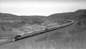 © Photo: Otto Perry Train #21, El Capitan, rolls down the Raton Pass near Lynn, New Mexico. Four EMD F3 units, led by engine #20, power the 11-car consist. The debut of the line's signature "Big Dome" and "Hi-Level" passenger cars is still four years off.