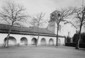 A portion of the monastery east elevation and chapel front façade (including the bell tower) at Mission San Juan Bautista as seen in 1934.