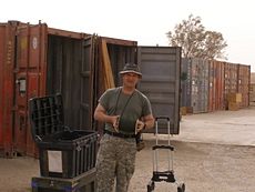 GI loads a shipping container