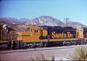 Santa Fe #4654, one of eighty SD26 rebuilds, descends the Cajon Pass on December 31, 1975. The unit's "blower bulge" (just aft of the cab) and displaced roof-mounted "torpedo tube" air reservoirs, its signature features, are clearly visible.