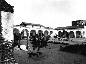 (PD) Photo: The University of California Archives The partially-restored plaza at Mission San Juan Capistrano as it appeared circa 1896. To the right is the sala, which served as the Mission chapel from 1891 until Serra's chapel was restored in the mid-1920s; the building also housed the Forster family during their time at the Mission.[6] Just left of center is Father Mut's former residence, including the loft he had constructed.[7]