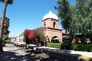 (CC) Photo: Robert A. Estremo The former passenger depot of the Atchison, Topeka and Santa Fe Railway in San Juan Capistrano, California (one of the earliest examples of Mission Revival Style architecture in railway stations) as it appeared in 2005. The plaster finish has been removed (exposing the brickwork beneath) at all but the dome of the original structure.