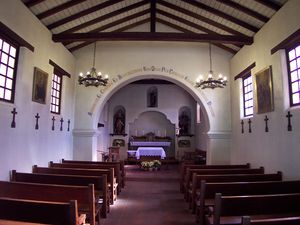 (CC) Photo: Robert A. Estremo A look inside the reconstructed (half-size) chapel at Mission Santa Cruz. Note the exposed wood beams that comprise the roof structure.