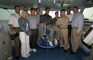 Picture of people posing for a camera on a US navy ship.