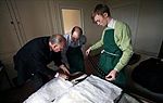 Butler Rick Fink (left), who runs a private butler valet school in Winston Churchill's former weekend mansion, demonstrates to two students the correct procedures for packing a suitcase.[41]
