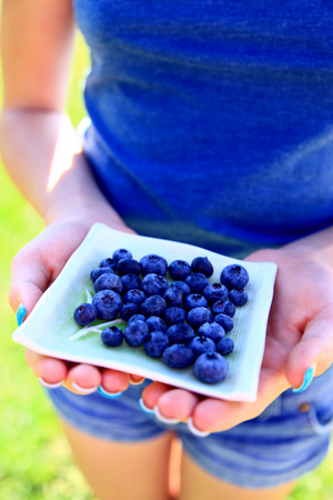 Girl in blue with blueberries.png