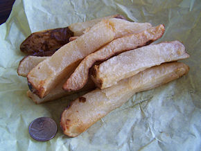 Potato log fries or simply potato logs, are prepared from very large unpeeled or peeled potatoes, often pre-cooked, that are cut about 1 inch (2.5 cm) by 1 inch (2.5 cm) to form "logs". A variant of potato logs is prepared similarly to wedge fries. Large, unpeeled, and often pre-cooked potatoes are quartered or cut into sixths or eights lengthways to form the logs and prepared. Potato logs are sometimes prepared through various baking methods. Note the coin (U.S. quarter) in the photo for size comparison. This serving was probably made from just one extra large potato.
