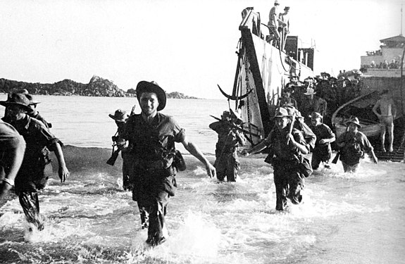 French Marines wading ashore off the coast of Annam (Central Vietnam) in July 1950, using US-supplied ships, weapons, equipment.
