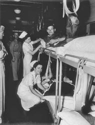 (PD) Photo: United States Army Signal Corps Wounded are being placed in berths of U.S. Army "Medical Department Hospital Ward Car" on Pier 5, Newport News, Virginia, May 29, 1943.