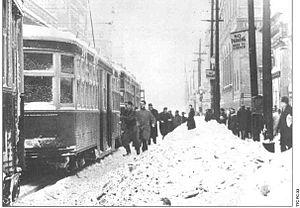 Passengers board northbound streetcars at Yonge and King on a snowy day -a.jpg