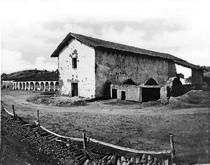 (PD) Photo: Carleton E. Watkins A view of Mission San Miguel Arcángel from the northeast side with a tile fence in the foreground, circa 1875.
