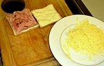 Ham on one of the slices and grated Gruyère ready to be added
