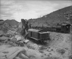 (PD) Photo: Los Angeles Times A steam shovel excavating for the San Diego and Arizona Railway line, circa 1919. An 0-4-0 steam locomotive maneuvers a string of ore cars in order to dispose of the soils.